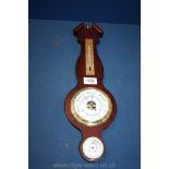 A small wooden barometer.