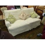 A cream shadow pattern foliage decorated 2/3 seater Settee