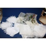 A quantity of lace and crochet including two tablecloths with lace edging and dressing table mats