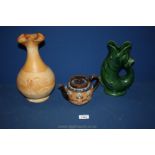 A Dartmouth pottery fish jug, a large ewer shape decanter with stopper with applied angel figures,