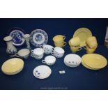 A part Teaset in yellow with a part coffee set in white with blue tulip design (saucer chipped),