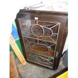 A dark Oak wall hanging Corner Cabinet, the door with most unusual pattern leaded glazing,