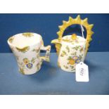 An unusual 19th Century Cantagalli teapot painted with flowers, 6 1/2'' tall and a matching jug,