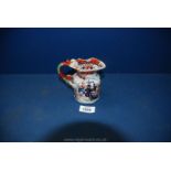 A small Masons jug with black mark to base in Imari style design with Greek key detail to rim and