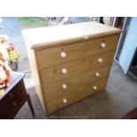 A Pine Chest of three long and two short drawers having white porcelain knobs/handles.