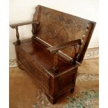 A dark Oak carved detail Monk's seat with compartment beneath the seat, 42" x 18 3/4" x 30" high,