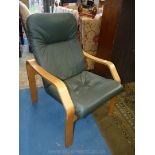 A contemporary light hardwood bentwood framed easy chair having green leather upholstered