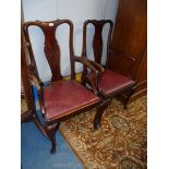 A pair of elegant Mahogany framed Elbow Chairs having cabriole front legs with pad feet and drop-in
