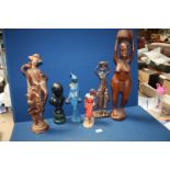 A quantity of figures including a carved wooden ethnic woman, a resin oriental lady,