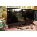 A Panasonic TX32ES 503B flat screen Smart Television and remote control