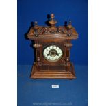 A German wooden eight day strike mantle clock with columns each side and a small crack down the
