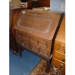 A 1940's/1950's Oak Bureau having two long drawers, fitted interior and standing on square legs,
