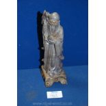 A well carved oriental stone figure of a Sage on a contrasting coloured plinth, 7 7/8'' high approx.