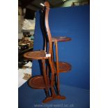 A double Mahogany folding cake stand. 34" tall.