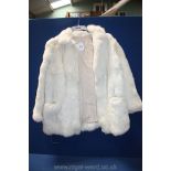 A cream short fur Jacket, possibly rabbit.