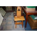 A light hardwood Arts and Crafts Chair having pierced shamrock motif to the backrest,