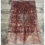 A red hand-made Kashan woolen Rug,