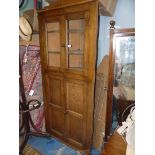 An Oak Corner Cabinet over Cupboard,