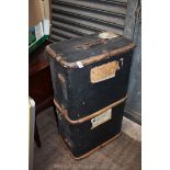 A large black travelling trunk with wooden banding and brass fittings, having W.D. Rogers on it.