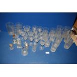 A quantity of floral embossed glasses including five large high ball glasses,
