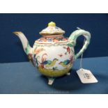 An unusual antique richly decorated teapot and cover with mask decoration,