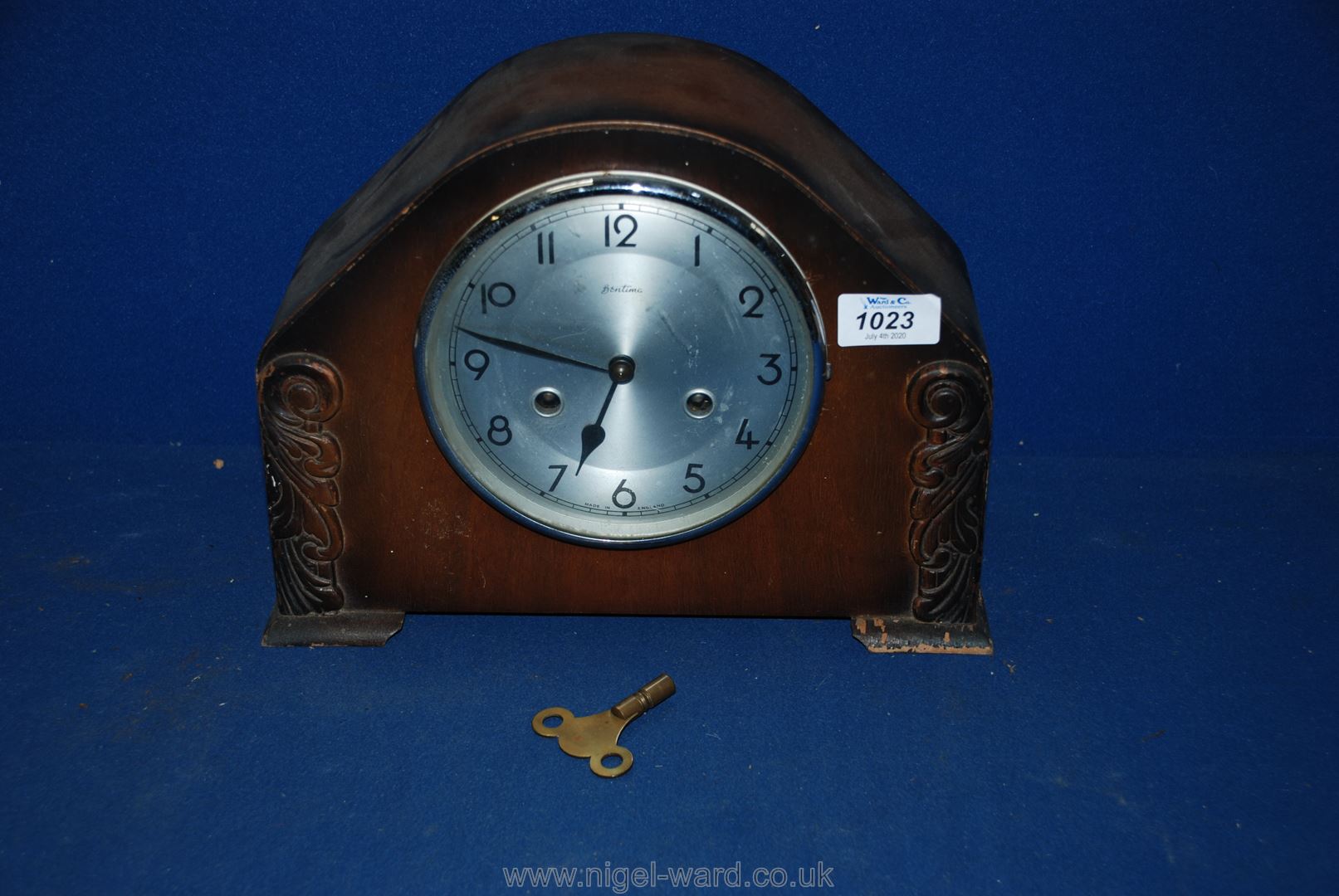 A Bentima mantle Clock with Arabic numerals and key.