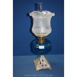 A blue glass oil Lamp with metal base with heron detail. 22" tall.