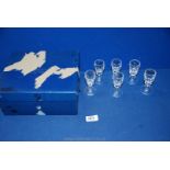 A boxed set of six Waterford crystal liqueur glasses.
