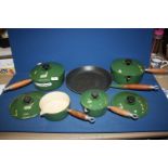 A set of green le Crueset pans.