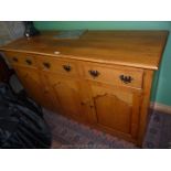 A craftsman made contemporary mid-Oak Sideboard having three frieze drawers and three shaped raised
