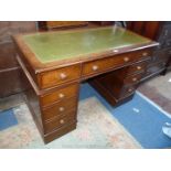 A dark Walnut finished double pedestal Desk having inset gold tooled green leather top,