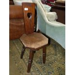 An Arts and Crafts octagonal seated mixed woods Spinning Chair the backrest with pierced heart