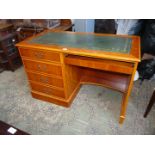 A cotemporary Yew wood single pedestal desk the top with inset gold tooled green leather surface,
