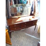 A Stag dark Mahogany dressing table with shaped mirror, 51 1/2" wide x 18 1/4" deep x 49" high.