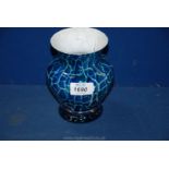 A Dartington Studio heavy glass vase in blue crazed effect with lime and white infill's,