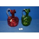 Two coloured glass ewers,