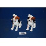 A pair of Royal Doulton character dogs with bones in their mouths.