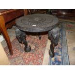 An ebonised circular Eastern occasional Table,