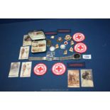 A small tray of Red Cross pins, badges, watch, photos etc.