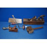 Three moulding planes, a wooden mallet and a drill brace.
