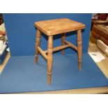 A hardwood rectangular topped Stool on turned legs and 'H' stretcher,