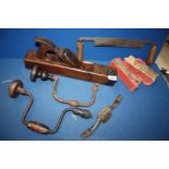 A box of early 20th Century woodworking tools; brace and bit, plane, draw knife, etc.