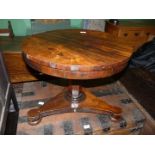 An early 19th century Rosewood Circular Occasional Table standing on a tapering hexagonal pillar