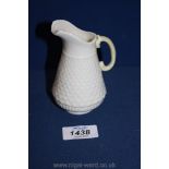 A small Belleek jug with fish scale texture design, green mark to base. 4 1/2" tall.