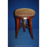 A circular Mahogany based Stool,