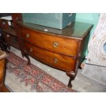 A bow fronted Mahogany Chest of two long drawers raised on cabriole legs and with plate glass