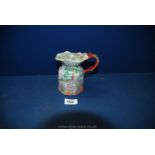 A small Masons jug with black mark to base, with oriental garden and figures design,