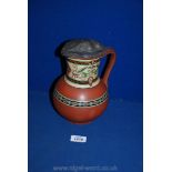 A 'Milan impressed terracotta jug, decorated with Italianate design panels 19th Century.