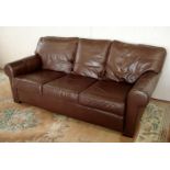 A brown leather upholstered three seater "Multi York" Settee.