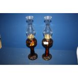 A pair of oil Lamps with brown glass spiral twisted bases and reservoir, 17" tall.